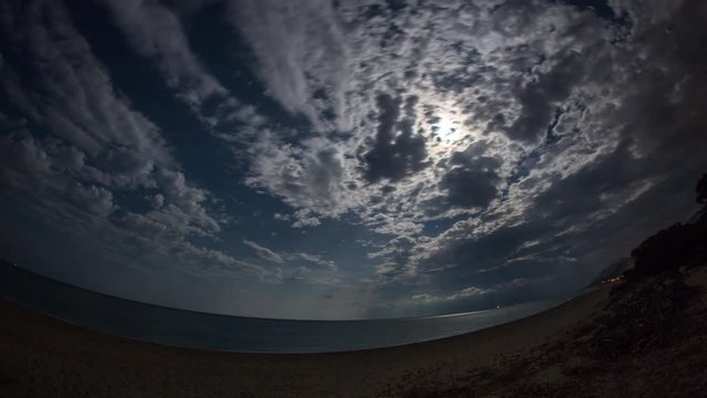 amazing star timelapse during a full moon of the coast in Sardinia, Italy.