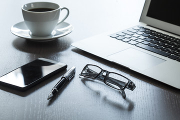 Business table with laptop and coffee