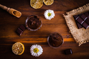Chocolate and spices on a wooden table