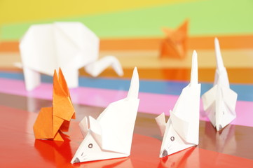 
Paper origami animals isolated on a colorful background