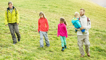 Large family having trekking walking day in landscape mountains