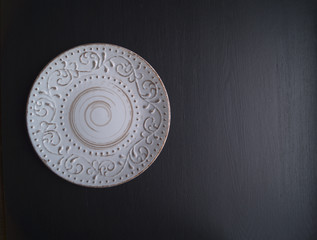 plate with ornament on black background