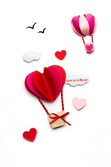 Fly to the sky / Creative valentines concept photo of clouds and hearts as aerostats on white background.