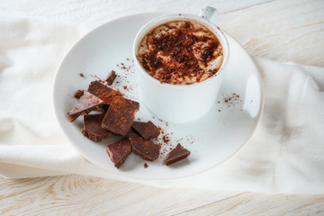 Mug of cocoa and chocolate on a plate