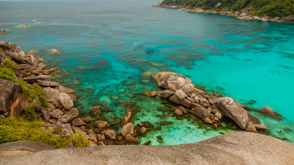 Scenic rocks cliffs and turquoise blue sea background in vintage style.