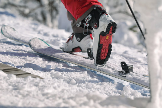 Detailed view of the ski bindings and skis lying on the piste