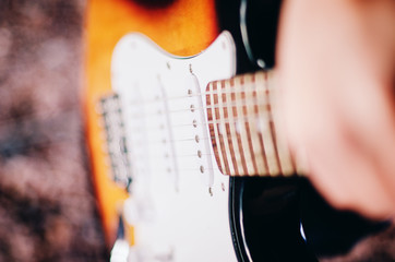 Close up electric guitar on hand of girl.