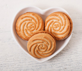 Tasty baked cookies on old wooden background.
