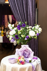 Violet bouquet, paper flowers and wedding bouquet lie on little