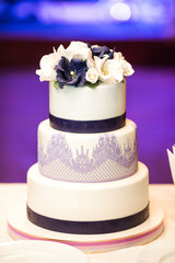 Beautiful wedding cake decorated with white and violet flowers a