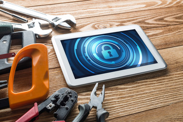 Web security and technology concept with tablet pc on wooden table © adam121