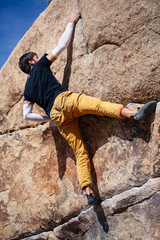 Young caucasian man climbs a granite cliff in the desert © Jeremy Francis