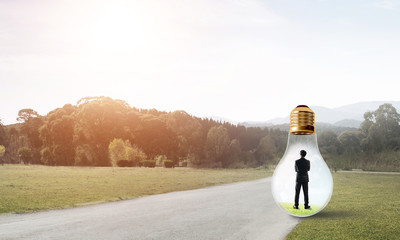 Businessman inside light bulb