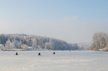 Winter fishing on frozen lake