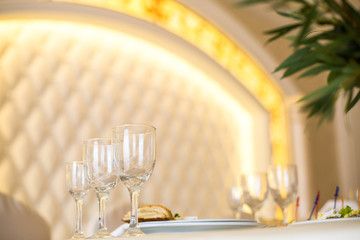 Look from below at sparkling glassware standing on dinner table