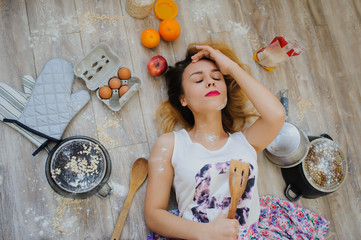 young woman lying on the floor in a vintage kitchen