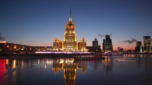 Evening view of the hotel "Ukraine" and the tourist boat, sailing along the Moskva river, Moscow, Russia