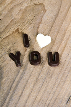chocolate words I LOVE YOU on wooden background