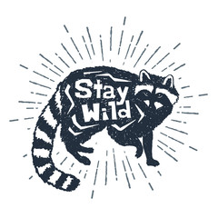 Hand drawnl label with textured raccoon vector illustration and "Stay wild" inspirational lettering. © SlothAstronaut