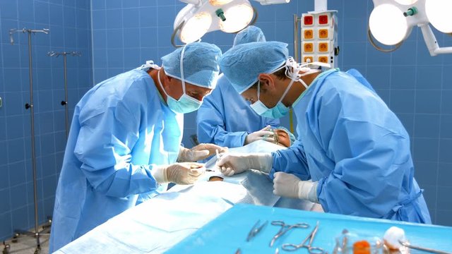 Surgeons performing operation in operation room at the hospital 4k