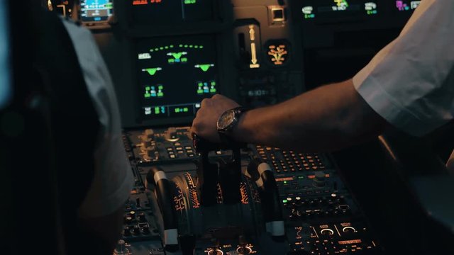 Close shot of cabin interior of Airbus A319 A320 A321. Flight deck and pedestal. Thrust and thrust reverse control levers and pitch trim wheel view