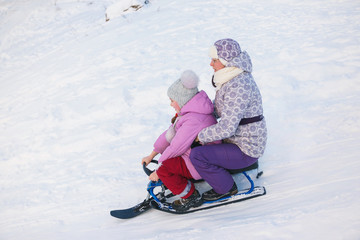 girls motion on a snow scooter
