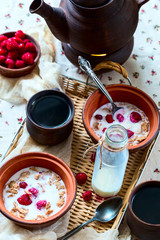 Breakfast for two. Black tea and muesli. Food located on a wicke