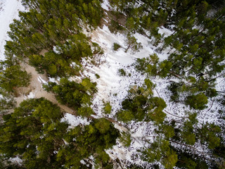 Obraz premium aerial view of frozen forest lake in winter