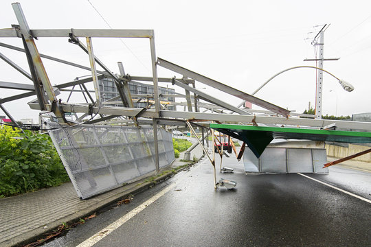 billboard demolished by wind in the highway in stormy day