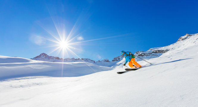 Freerider skier running downhill