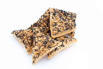 Crisps with nuts and seeds stacked on a white background.