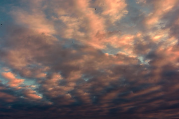 colorful sunset with pocked clouds.