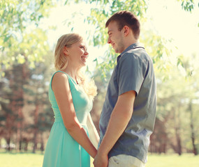 Happy young smiling couple in love together at sunny spring day