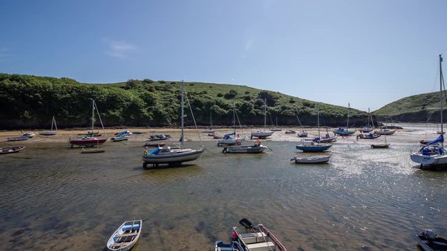 epic timelapse shot filmed over 7 hours of  the port of Solva in Wales. during this long period of time the water empties out of the bay into the sea leaving the boats stranded in sand