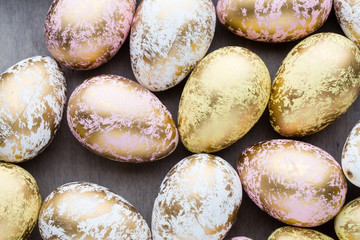 Easter eggs painted in colors on a pattern background.