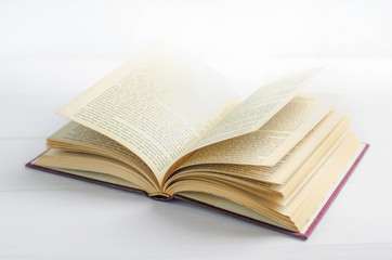 Old book opened on white background