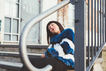 Portrait of young handsome eastern woman outdoor in the city having fun laughing - happiness, carefree, serene concept