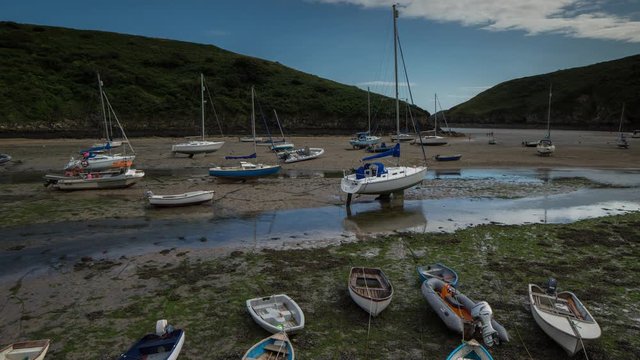 epic timelapse shot filmed over 7 hours of  the port of Solva in Wales. during this long period of time the water empties out of the bay into the sea leaving the boats stranded in sand
