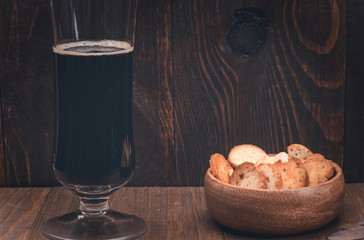 dark beer and croutons on a wooden background/beer and croutons on a wooden background