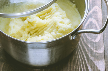 pan with mashed potatoes potato on a wooden table. Top view/pan with mashed potatoes potato on a wooden surface