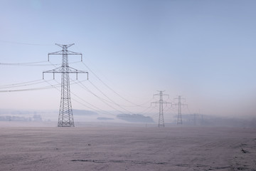 high voltage pylons in winter on a sunny day