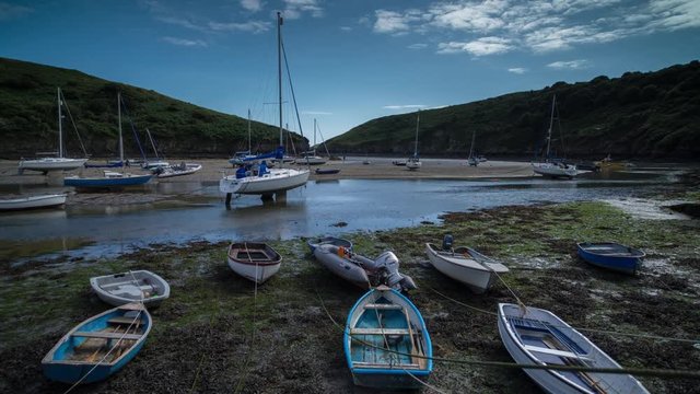 epic timelapse shot filmed over 7 hours of  the port of Solva in Wales. during this long period of time the water empties out of the bay into the sea leaving the boats stranded in sand