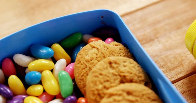 Close-up of cookie with sandwich and confectionery in a box 4k