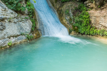 Fototapeta premium Neda Waterfalls among the rocks and forest, Greece
