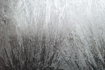 Surface of a window glass with frostwork as a background