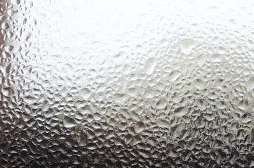 Windowpane with frozen water drops as a background