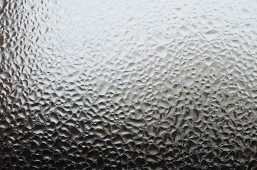 Window glass with frozen water drops as a background