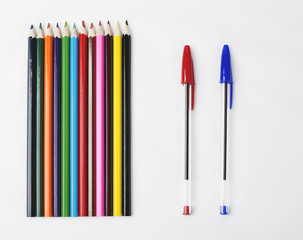 Wood pencils and two pen on white background