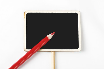 Red wooden pencil on a square blackboard on white background