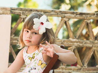Caucasian little girl with flower in hair